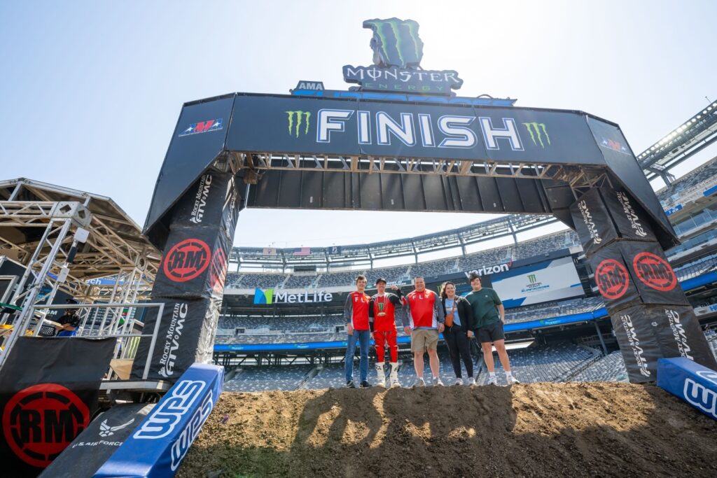 Former St. Jude patient Owen (left), his family, and Supercross racer Josh Hill at the Love Moto Stop Cancer Race in East Rutherford, NJ. Photo Credit: Feld Motor Sports, Inc.